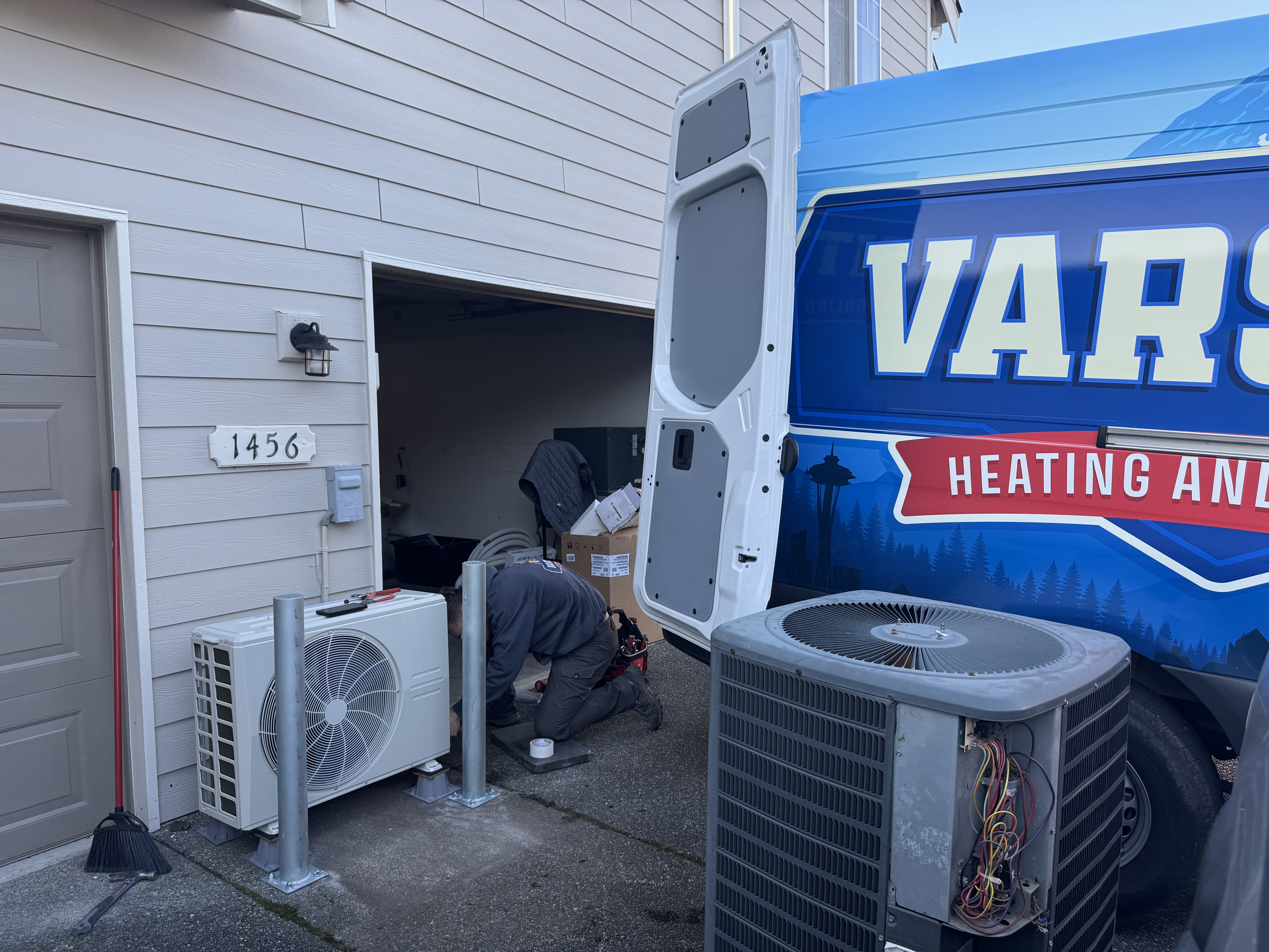 Varsity technician working on a condenser unit